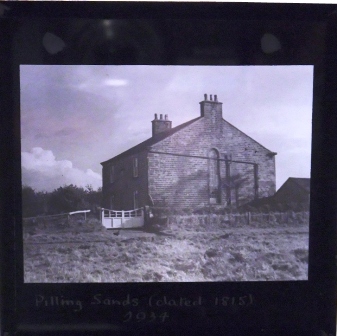 Glass slide of what appears to be a farm, dating from 1934 it is entitled 'Pilling Sands dated 1815.'