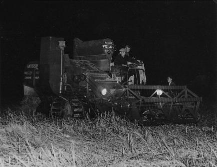 Two photos of harvesting by floodlight, Peel Hall Farm 1956.