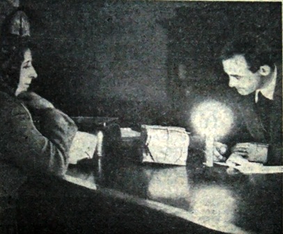 Blackpool General Post Office, mid-February,1947.A lady is posting a parcel with the clerk working by candlelight. 